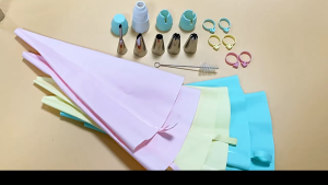 Mint green silicone piping bag set with stainless steel tips and accessories for cake decorating.