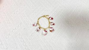 Sanrio | Gold Tone HelloKitty Charm Bracelet Zinc Alloy with Multi Kitty Enamel Charms Adjustable Paperclip Link Chain for Girls & Fans