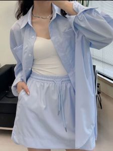 ชุดเสื้อเชิ้ตแขนยาวกันแดดสีพื้นและกระโปรงสั้นหลวมสไตล์เกาหลีฤดูใบไม้ผลิและฤดูใบไม้ร่วง ชุดแฟชั่นสำหรับผู้หญิงวัย 18-25 ปี