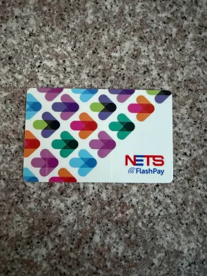 Nets FlashPay Card with colorful arrow pattern on white background.