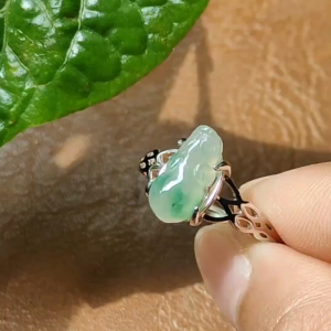 Crafted as Pixiu on Light Green Hue with Light Green Patches Natural Type A Jadeite Jade set with S925 as adjustable ring certificate weighs 2.01 grams measurement 11.8 * 5.5 * 3.8 mm (s925ring27)