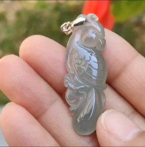 Premium Old Pit Rare Green Hue Icy Translucent Natural Type A Jadeite Jade crafted with Parrot as Pendant for the collectors certificate weigh 6.25 grams measurement 41.6 * 15.2 * 6.5 mm (pendant213)