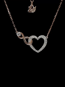 Swarovski Infinite Heart Jewelry collection necklaces and bracelets finished in rose gold and rhodium tones clear crystal