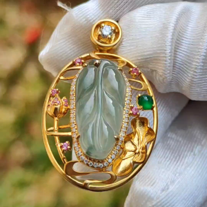 Premium Quality Icy light green with patches Natural Type A Jadeite Jade crafted as Leaf set on 18k Gold with 1 Green Cabochon and Diamonds Certificate included weigh 4.36 grams Measurement 35.3 * 22 * 8.2 mm (18kp25)