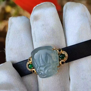 Light Green Hue Natural Type A Jadeite Jade crafted as Pixiu set on 18k Gold with 2 Green Cabochon and diamonds adding PU wrist band upgraded elegant style bracelet certificate weigh 4.44 grams measurement 16.6 * 14.1 * 7.5 mm (18kpw1)