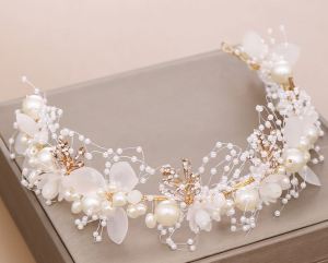 Pearl and floral headband for formal occasions. White flowers pearls and silver accents. Suitable for weddings or parties. Elegant accessory for special events.