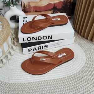 Brown and beige flip-flop sandals with metallic accents.