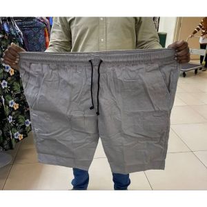 Mens beige drawstring shorts with elastic waistband and side pockets. Casual summer wear.