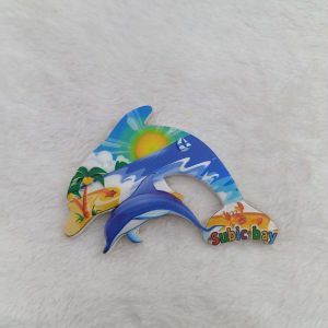 Subic Bay Philippines souvenir magnet with house and palm trees and dolphin magnet with beach scene.