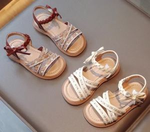 Trendy summer sandals for girls featuring floral embroidery a princess-style open-toe design and a sweet bow embellishment. These casual sandals have a soft sole.