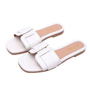 White flat sandals with square toe and decorative strap.