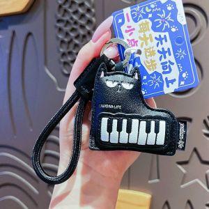 NEXTYOO Mèo đen Móc khóa da Da PU Hình dáng của đàn piano. Móc khóa hình nhạc cụ Di động Có dây đeo Móc khóa hình mèo đen. Dành tặng bạn bè.