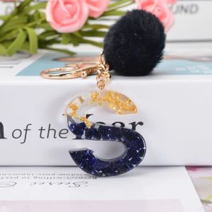 Black Personalized Simple Pompom Hairball 26 English Letter Gold Foil Resin Keychain Pendant for Men and Womens Bags Charm Accessories Pendant