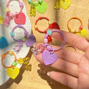 EIJINGY การ์ตูนลายการ์ตูน พวงกุญแจรูปหมีหัวใจเป็นประกาย สีลูกอมสี โปร่งใสโปร่งใส จี้กระเป๋าน่ารัก ทันสมัยและทันสมัย ตัวอักษรสำหรับเด็ก พวงกุญแจหมีกัมมี่เรซิ่น เครื่องประดับกระเป๋าประดับ
