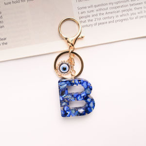 พวงกุญแจตัวอักษรพิมพ์ใหญ่ พวงกุญแจตัวอักษรภาษาอังกฤษแวววาว สีน้ำเงินรอยัล พวงกุญแจตัวอักษรภาษาอังกฤษ 26 ตัว ตาปีศาจ  พวงกุญแจกระเป๋าสำหรับผู้หญิง