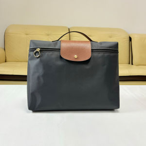 The 2025 new nylon hand-held briefcase fashionable dumpling-shaped handbag is suitable for business commuting can hold a 14-inch laptop is foldable and can be used as a casual document bag.
