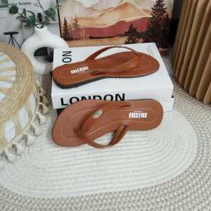 Brand: mimi Main product: Flip Flops Key attributes: Brown color beige straps textured sole Fit/use: Casual wear indoor/outdoor Scene: On books on rug