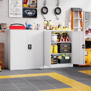 White metal storage cabinet with lockable doors  for garage or workshop. Contains tools cleaning supplies and safety equipment.