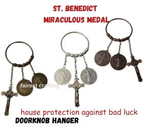 St. Benedict Miraculous Medal Door Knob Hanger. Designed to hang on your door handle it serves as a powerful Catholic symbol against bad luck evil and negative energy.
