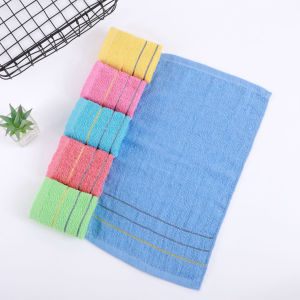 Blue towel with yellow stripes and five folded towels in yellow pink blue red and green.