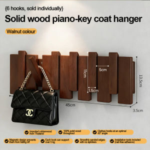 Wooden wall hook rack with slatted design for hanging bags and hats. Fits in entryway or hallway. Displayed in a home setting with a door and light fixture