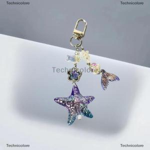 [COD] Technicolore สายคล้องโทรศัพท์ลายปลาดาวสีม่วงสวยเก๋ทรงหางปลาสวยงามเคสพร้อมจี้รูปกล้องสายคล้องกระเป๋าของตกแต่ง