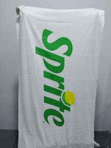 7 Eleven Sprite branded towel with green logo and yellow dot on white fabric