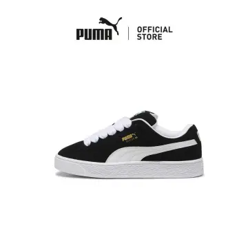 Black fashion and white suede pumas