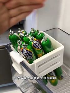 Expandable Fridge Door Storage Divider Clip - Clear plastic compartments with white clips for organizing bottles and packets on fridge door.