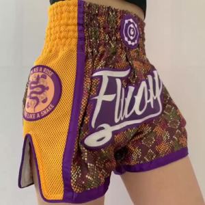 2025 Quần short Muay Thai Fluory 1 mảnh mới quần tập boxing vàng quần áo boxing nam quần short chiến đấu miễn phí cho phụ nữ tùy chỉnh chiến đấu miễn phí