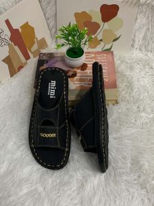 K89 Black slip-on sandals with gold stitching and branding. Casual indoor footwear.