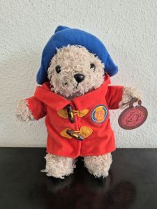 Paddington bear plushie in a red coat with a blue hat