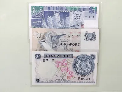 VINTAGE SINGAPORE ONE DOLLAR BANK NOTES SET: SHIP (UNC) BIRD (UNC) AND ORCHID (USED) SERIES (3 PIECES)