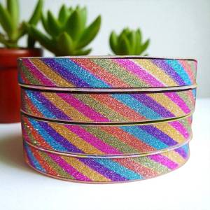 ส่งฟรี ช็อปขั้นต่ำ ฿99 (ส่งไว) ริบบิ้นกากเพชร สีรุ้งอัดลาย ตราTW เนื้อแข็ง แบบทึบ ม้วนเล็ก ยาว 50 หลา ขนาด 12 mm. พับเหรียญโปรยทาน