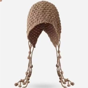 Hand-knitted wool hat with tassels and pom-poms warm and ear-covering.