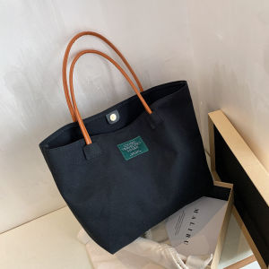 NIkyLundun   ฤดูใบไม้ผลิใหม่แฟชั่นผ้าใบกระเป๋าโท้ทหนังที่จับเรียบง่ายสไตล์สตรีทหัวเข็มขัดแม่เหล็กเปิดและปิดความจุขนาดใหญ่ในชีวิตประจำวันแมทช์ลุคง่าย