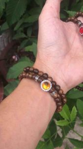 Vòng tay trầm hương tốc tự nhiên mix charm đá màu.