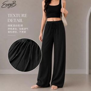 EasyB | Black wide-leg pants with elastic waist. Lightweight breathable fabric. Casual comfortable fit. Suitable for relaxed outings.