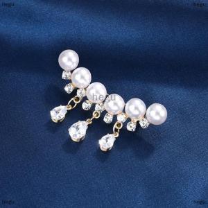 [COD] hegu เข็มกลัดไข่มุกคริสตัลสีขาวสง่างามสำหรับผู้หญิงเข็มกลัดติดพู่พลอยเทียมรูปหยดน้ำสีทองหรูหรา