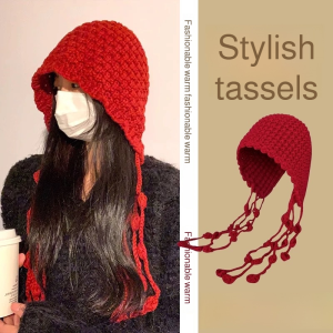 Hand-knitted wool hat with tassels and pom-poms warm and ear-covering.