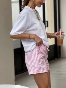 New elegant short-sleeved summer T-shirts for women featuring a loose fit with a distinctive shoulder cut and a round neckline a Japanese and Korean-style cartoon puppy print suitable for casual wear and various styles and a cute look.