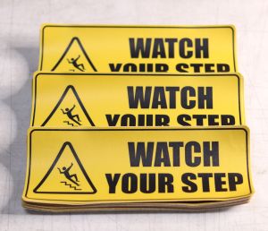 DSign Watch Your Step 10x4" inches Sticker Signage Vinyl l Door Sign l Waterproof | Scratchproof