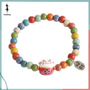 ส่วนลด 10 บาท สำหรับการซื้อ 1 ชิ้น สร้อยข้อมือแฟชั่นน่ารักเซรามิกรูปแมวนำโชคสำหรับเด็กผู้หญิงกำไลลูกปัดหลากสีปรับได้จี้รูปแมวเครื่องประดับสร้อยข้อมือนำโชคน่ารัก