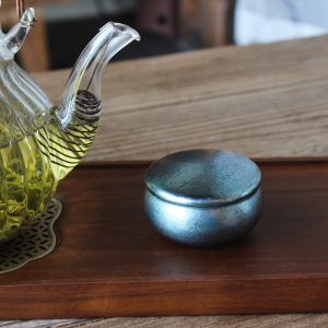 Pure titanium tea canister round design suitable for tea ceremonies portable for outdoor use compact size ideal for storing tea at home or in the office and features moisture-proof properties