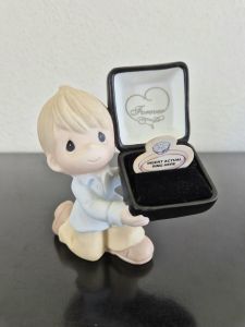 Precious Moments boy holding a ring case