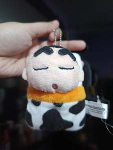 Shin Chan Charm Plush keychain featuring cartoon character with closed eyes and cow print blanket
