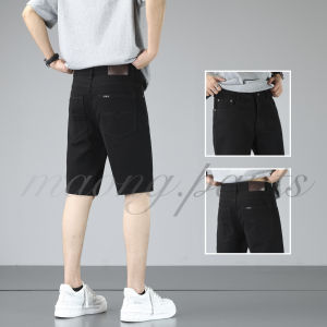 Mens black denim shorts with leather patch back pocket and belt loops. Casual fit with white sneakers.