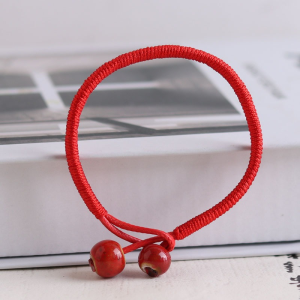 Red string bracelet with round beads symbolic meaning everyday use