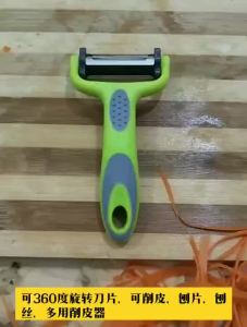 Rotary Vegetable Peeler with dual blades for peeling and shredding ergonomic green handle suitable for home kitchen use organized storage.