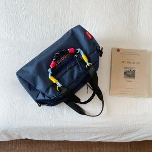 Lightweight bowling bag with a simple design and large capacity. This nylon shoulder bag features an adjustable strap and is a casual tote bag for women suitable for both indoor and outdoor use.